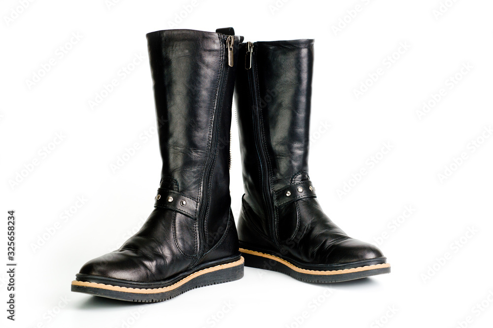 Black leather women’s boots fastened with a zipper. Background for shoes.