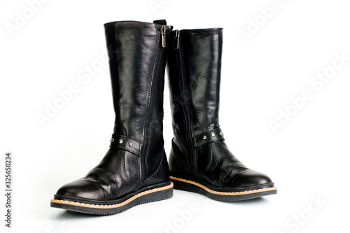 Black leather women’s boots fastened with a zipper. Background for shoes.