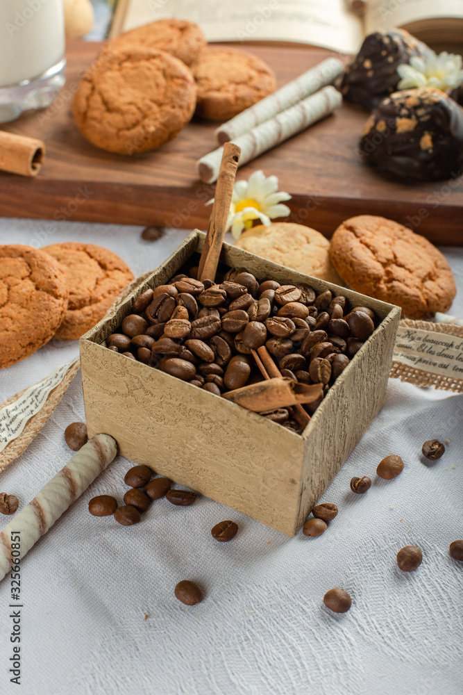 Coffee beans and cookies on a blue tablecloth.