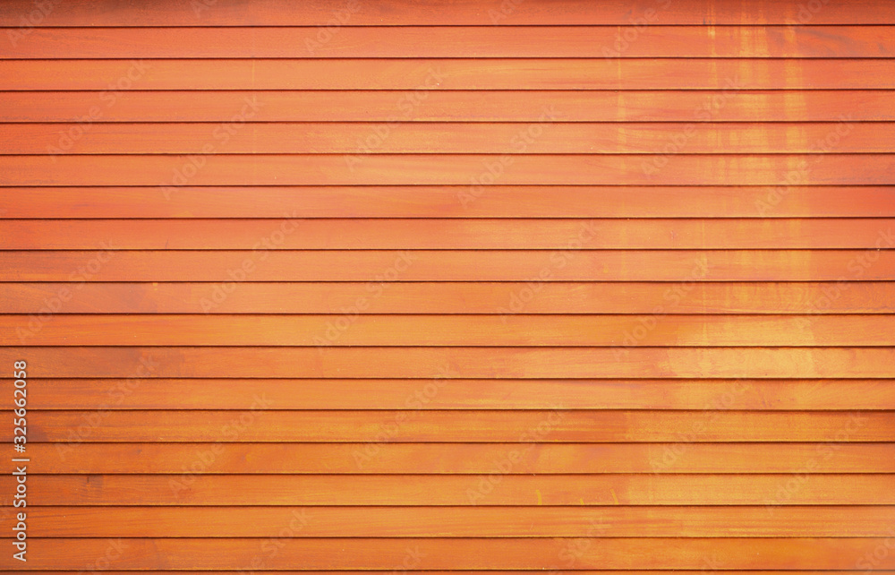The wall of the wooden house is painted yellow and orange The wall of the wooden house is painted yellow and orange