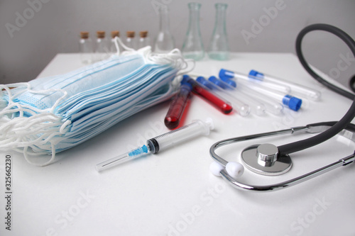medical laboratory test tubes, stethoscope, disposable protective masks, concept of individual protection against virus, COVID-19 coronavirus, flu, infection