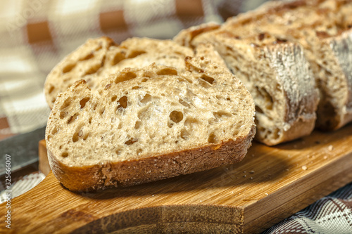loaf of bread on wooden background, food closeup.Fresh homemade bread.French bread. Bread at leaven.Ciabatta.