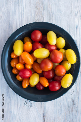 ripe cherry tomatoes in a dark plate