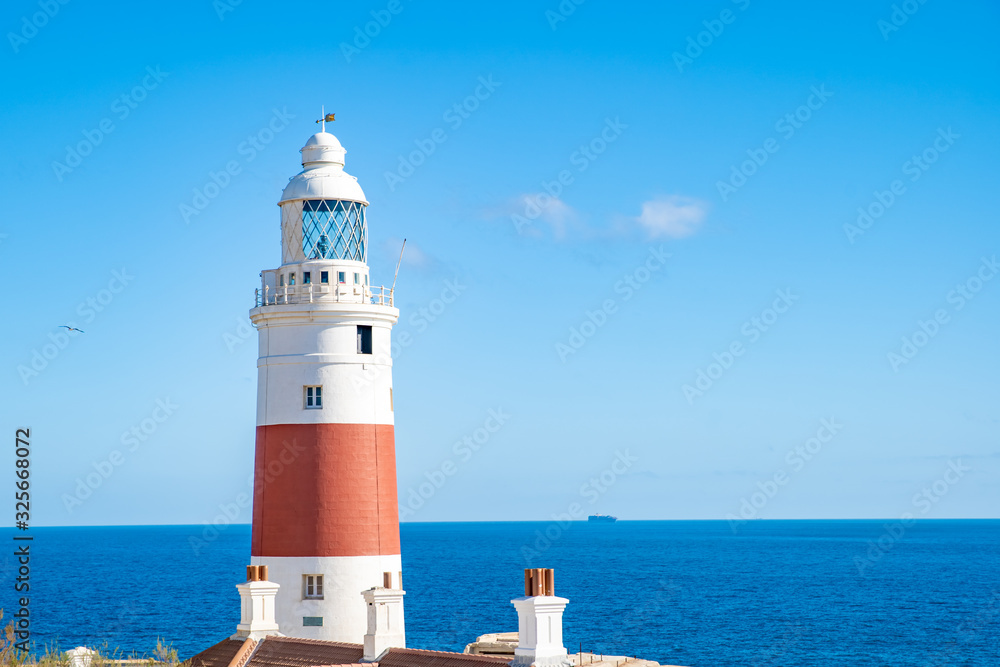 a lighthouse on the coast of the ocean serves to indicate the direction of lost ships