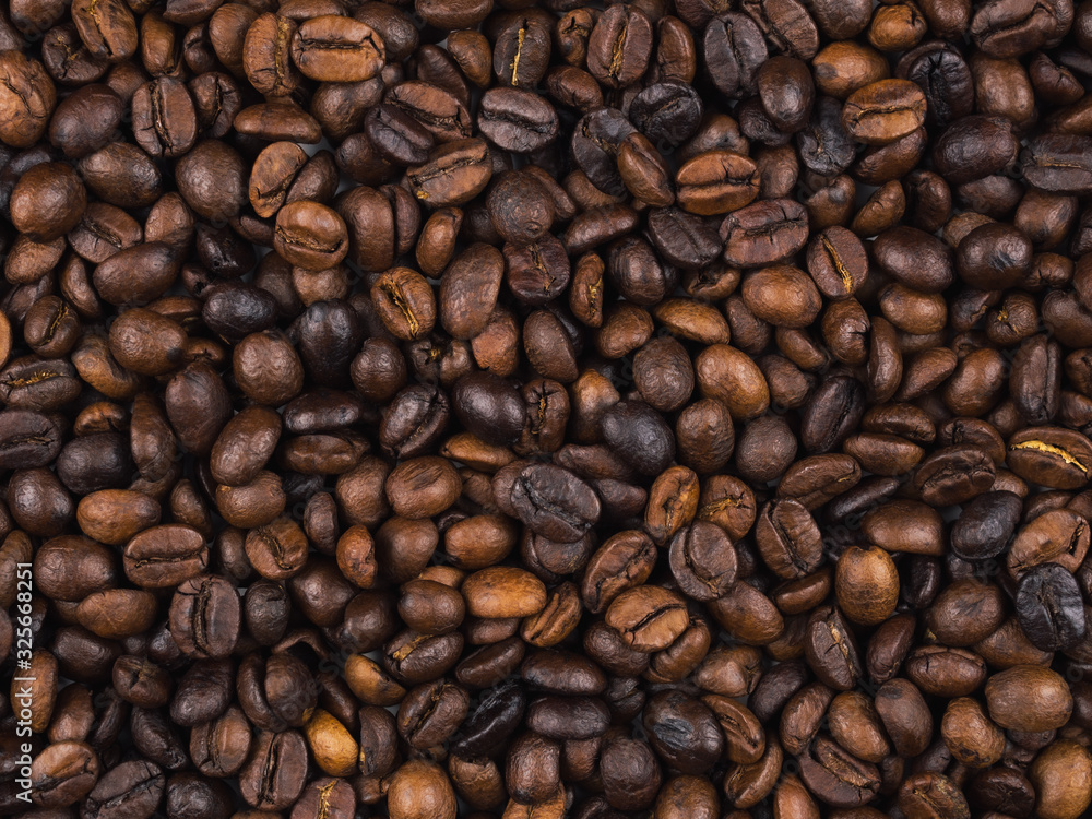 Fototapeta premium Close-up and top view of roasted Thai coffee beans texture background.