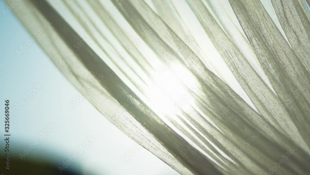 The sun's rays passing through the tulle.