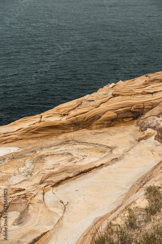 Detail shot of the sandstone waters edge in Bouddi National Park. © Nick