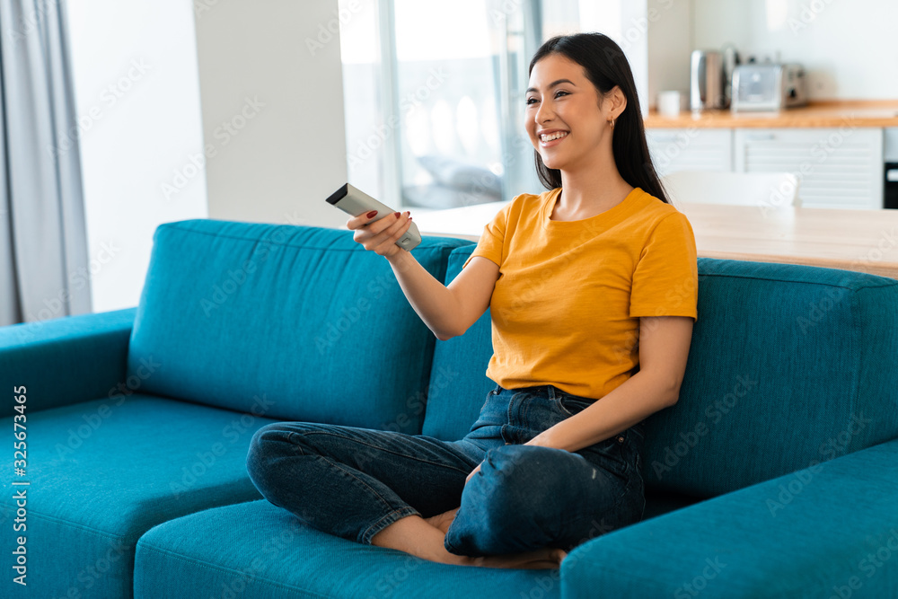 Cheery brunette young woman on sofa Cheery brunette young woman on sofa