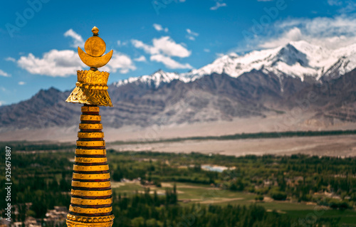 Gold stupa in Buddha monastery against mountains