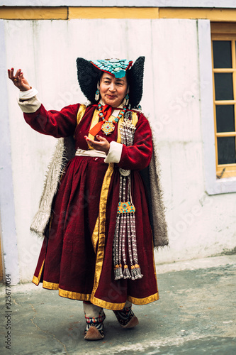 Woman dancing typical folkloric dances in traditional costume in Ladakh, Kashmir, India