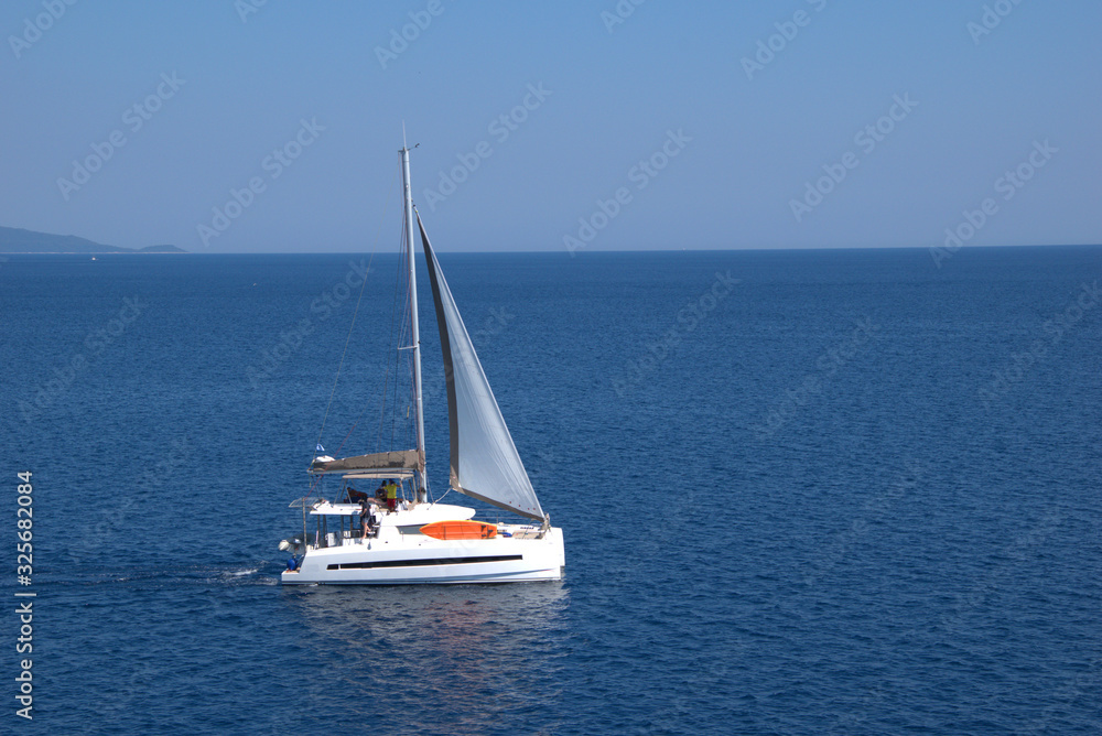  sailboat sails in the mediterranean sea , between the islands of the Aegean Sea