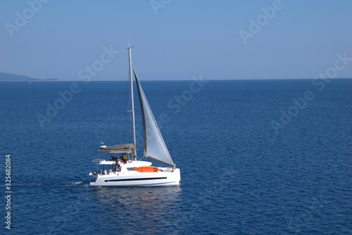  sailboat sails in the mediterranean sea , between the islands of the Aegean Sea