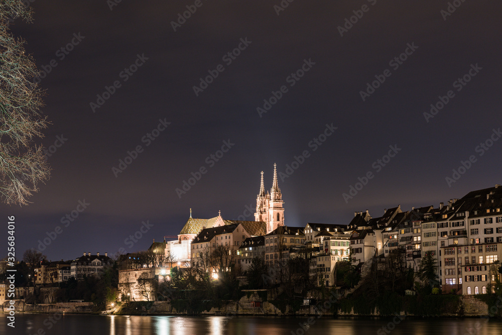 view of the rhine and basel cathedral at night