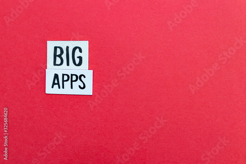 BIG APPS text on label and red background. Modern minimal and fresh background for companies and startups that deal with mobile app development. Mobile background app with copy space for custom text