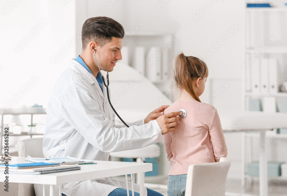Pediatrician examining little girl in clinic Pediatrician examining little girl in clinic