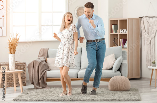 Happy dancing young couple ...