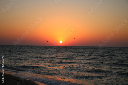 pink sunset by the sea in summer on vacation, beautiful sky unusual