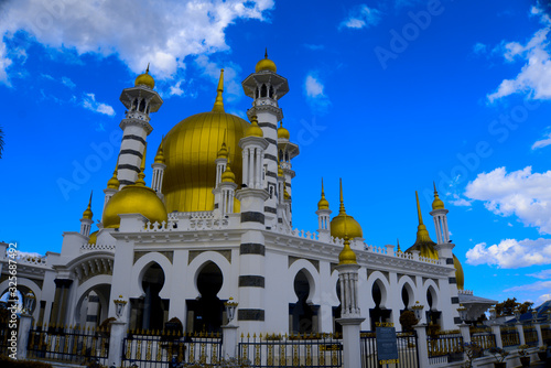Mosque with golden dome and blue sky