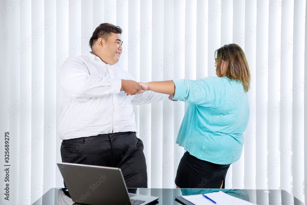 Fat couple dancing and holding hands together Fat couple dancing and holding hands together
