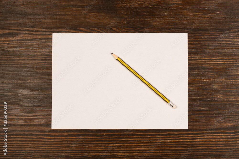 paper and pencil on wooden desk paper and pencil on wooden desk