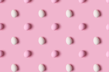 Pattern of pink and white Easter eggs over pink background