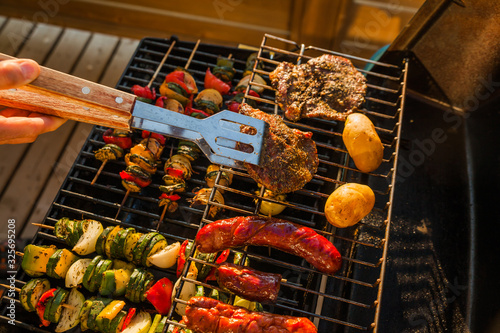 Grilling meat outdoors during a weekend rest