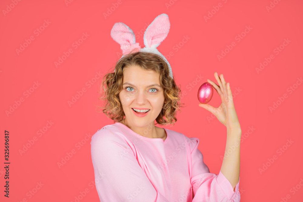 Egg hunt. Happy Easter hunt. Woman with rabbit ears holds Easter egg. Woman in bunny ears holds Easter egg. Rabbit girl. Easter eggs. Spring time. Spring holidays. Holiday.