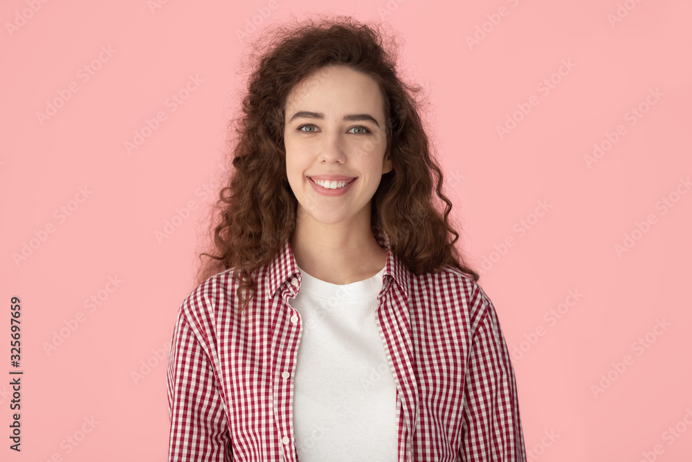 Happy smiling sincere millennial curly woman head shot portrait. Happy smiling sincere millennial curly woman head shot portrait.