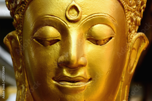 Closeup detail of golden buddha statue © Siwapot Narukietmont