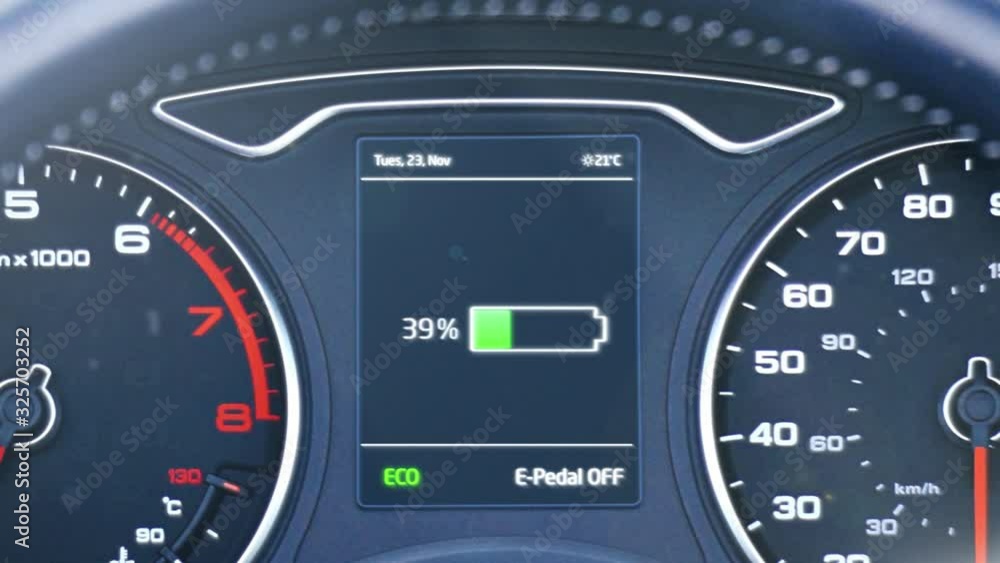 Dashboard of an electric car as the battery charges at a charging station. The battery indicator fills from zero to one hundred. Clip contains a battery charging graphic and battery percentage rising. Dashboard of an electric car as the battery charges at a charging station. The battery indicator fills from zero to one hundred. Clip contains a battery charging graphic and battery percentage rising.