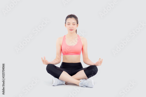 Beautiful portrait young asian woman sitting yoga, asia girl health care with workout fitness relaxing with active exercise isolated on white background, healthy and wellbeing concept. © N_studio