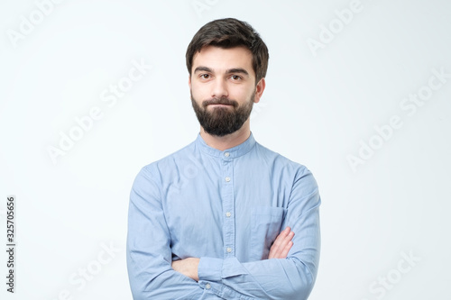 Young hispanic man frowning face in displeasure