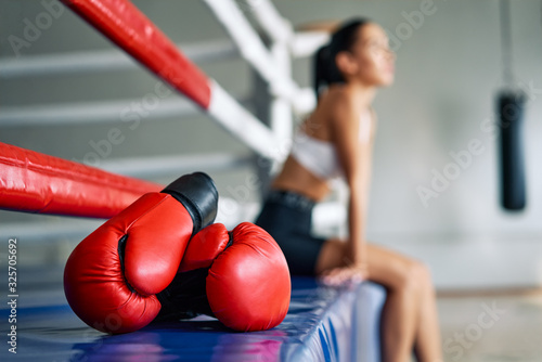 Red boxing gloves on boxing ring in gym © GVS