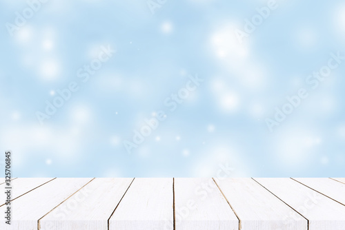 empty wooden table with pastel blue bokeh background