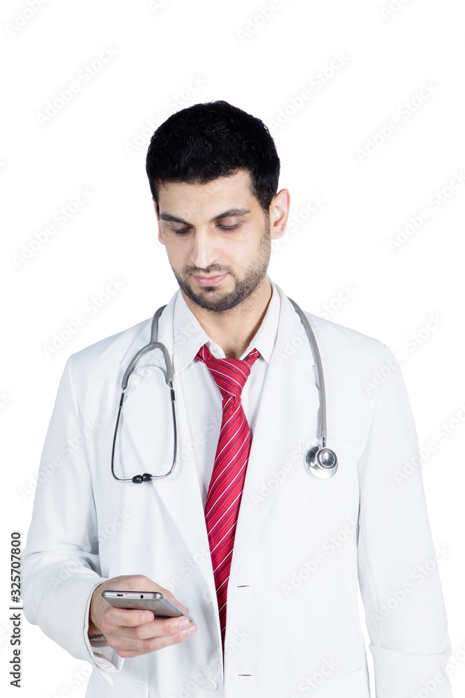 Fototapeta premium Young doctor typing message on mobile phone