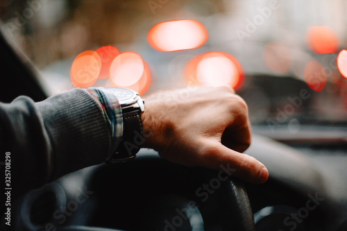 Close up of male hand on steering wheel. Man driving car during © finwal89