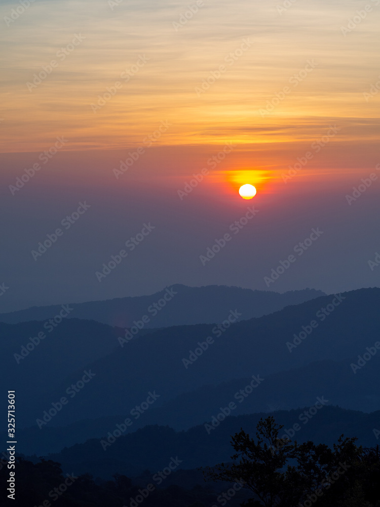 dramatic sunset over cloudy sky.