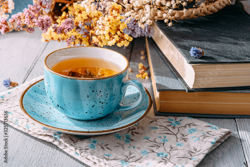 tea and a book in the spring sunshine. near honey and flowers