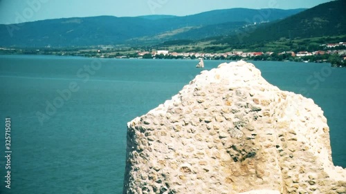 Old and not reconstructed castle wall and view to river Danube
