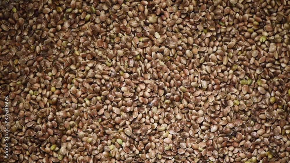 Hemp seeds on rotating background. Grains and seeds texture. Food ingredient backdrop. Top view, healthy lifestyle concept. Vegan healthy nutrition Hemp seeds on rotating background. Grains and seeds texture. Food ingredient backdrop. Top view, healthy lifestyle concept. Vegan healthy nutrition
