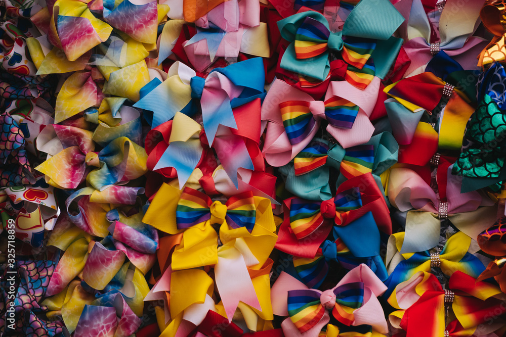 Quirky, colorful bowties hanging from a wall at a market. Quirky, colorful bowties hanging from a wall at a market.