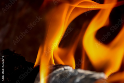 wood fire view,close up of a bonfire with glowing wood and orange flames