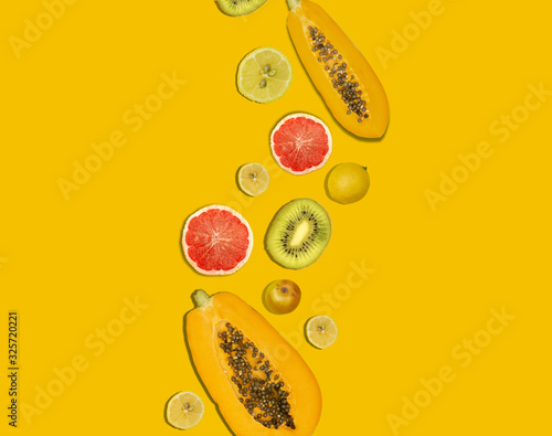 Fototapeta Naklejka Na Ścianę i Meble -  Collage photo of papaya and grapefruit with yellow copy space, fruit concept