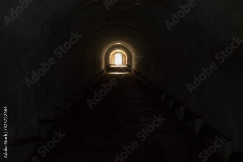 A lighted door leading to freedom from a gloomy dark underground passage at Pospelov Fort in Vladivostok.