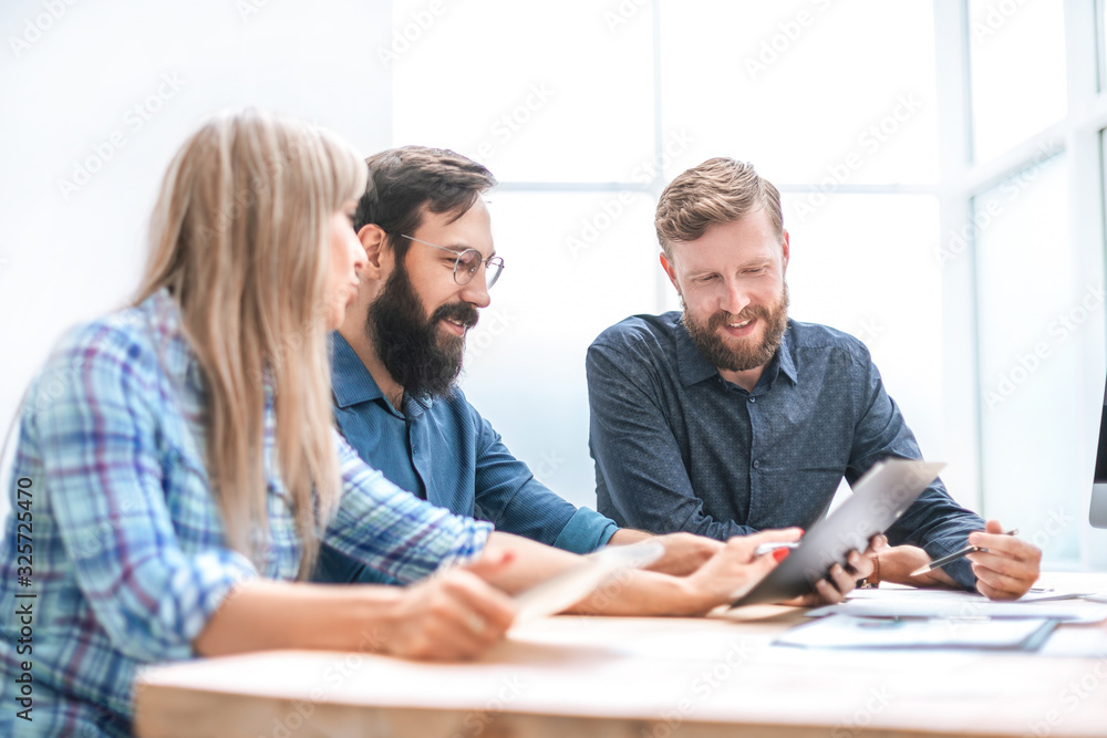 close up. a group of designers discussing documents for a new project. close up. a group of designers discussing documents for a new project.
