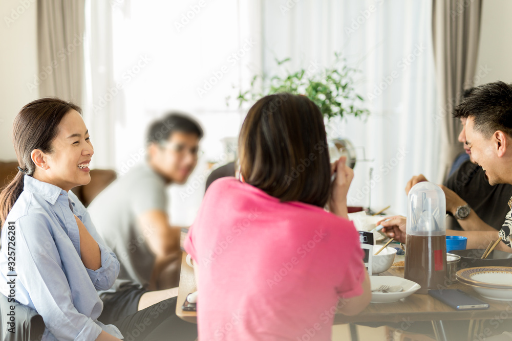 Group of friends enjoying lunch together at home, selected focus. Group of friends enjoying lunch together at home, selected focus.