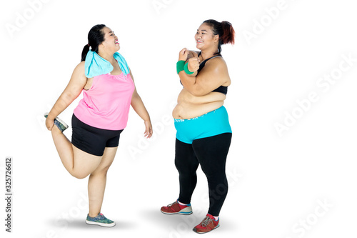 Fototapeta Naklejka Na Ścianę i Meble -  Overweight woman doing warm up before exercising