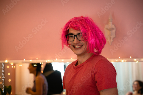 Doll costume party. The guy smiles at the wig