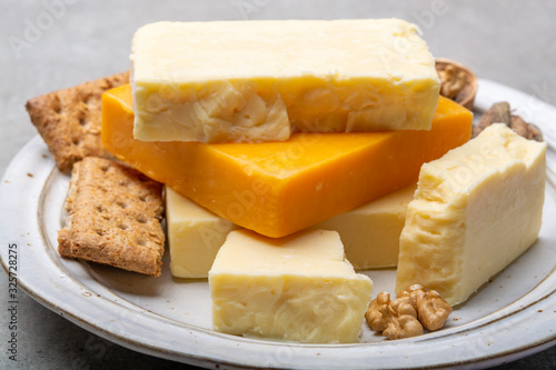 Cheese collection, matured and orange original British cheddar cheese in blocks served with crackers
