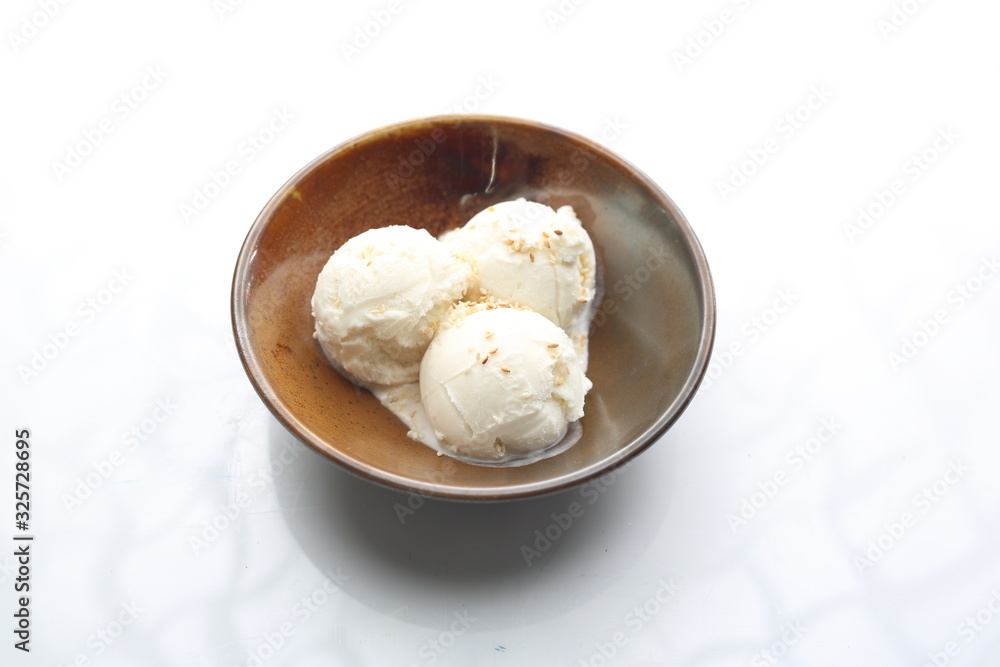 Three scoops of ice cream in a bowl. Appetizing dessert isolated on white. Three scoops of ice cream in a bowl. Appetizing dessert isolated on white.